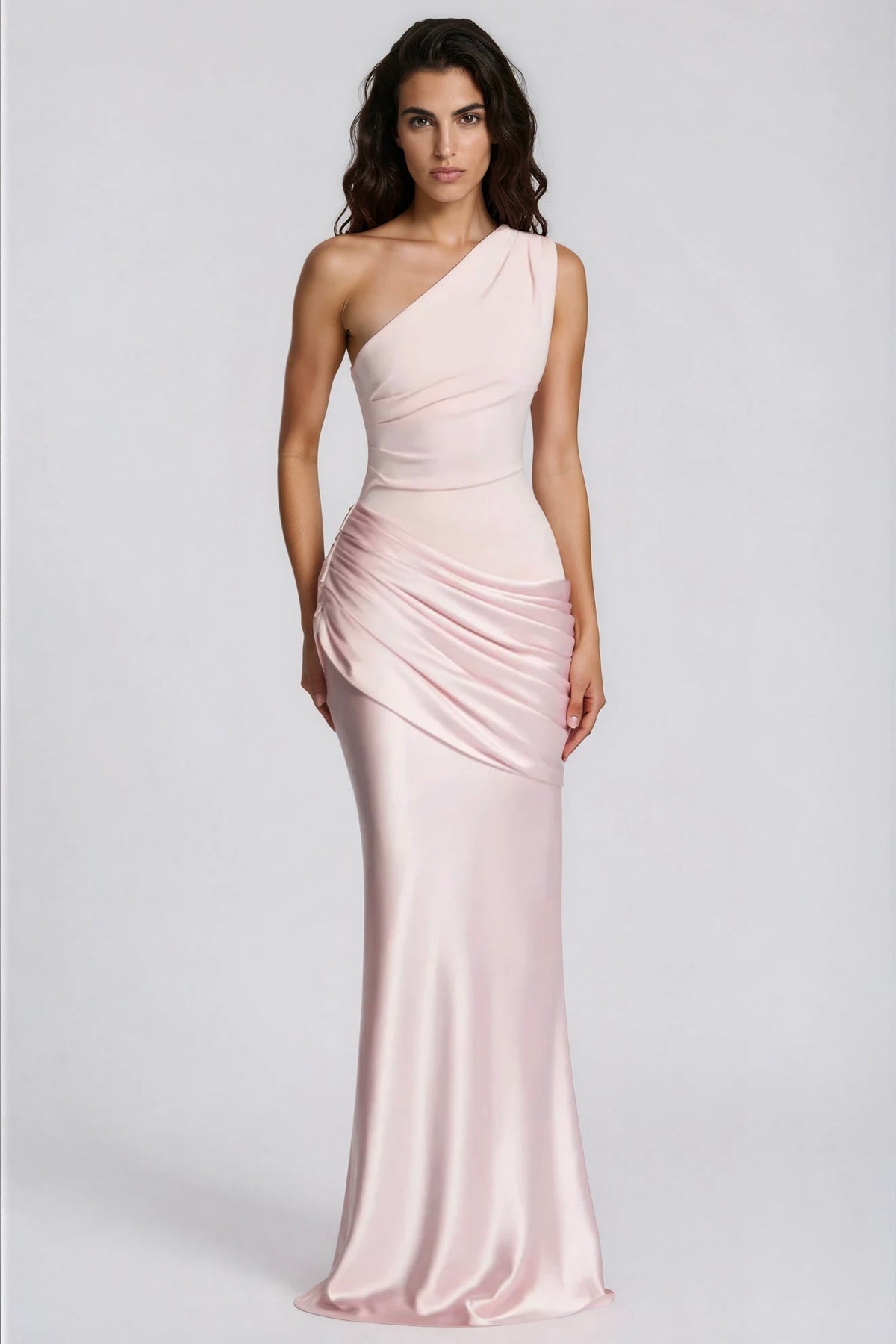 Straight-on front view of the pale pink one-shoulder maxi dress with a pleated bodice and gathered satin waist. 32
