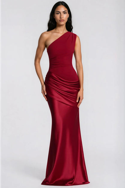 Front view of the deep red one-shoulder maxi dress on a model, with a ruched crepe bodice and draped satin waist. 34
