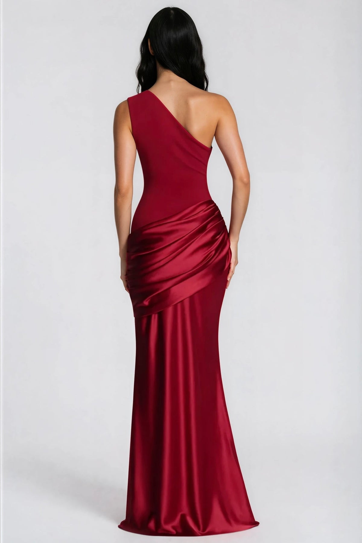 Back view of the deep red one-shoulder maxi dress, showing the asymmetric strap and the gathered satin drape over the hips. 35