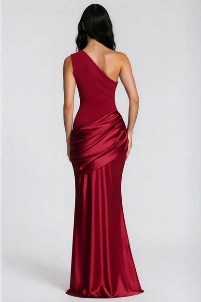 Back view of the deep red one-shoulder maxi dress, showing the asymmetric strap and the gathered satin drape over the hips. 35