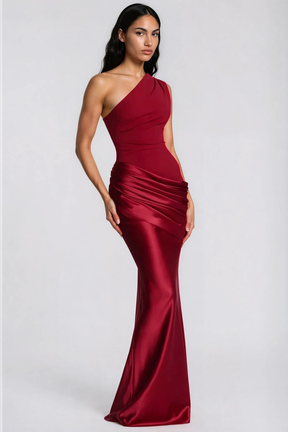 Angled view of the deep red satin maxi dress, showing the fitted bodice, draped waist and flared mermaid-style hem. 36