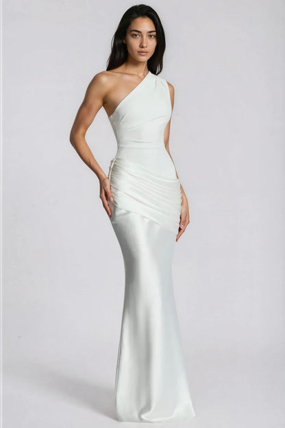 Angled front view of the white dress with one hand on the hip, showing the draped satin panel and slim skirt. 11