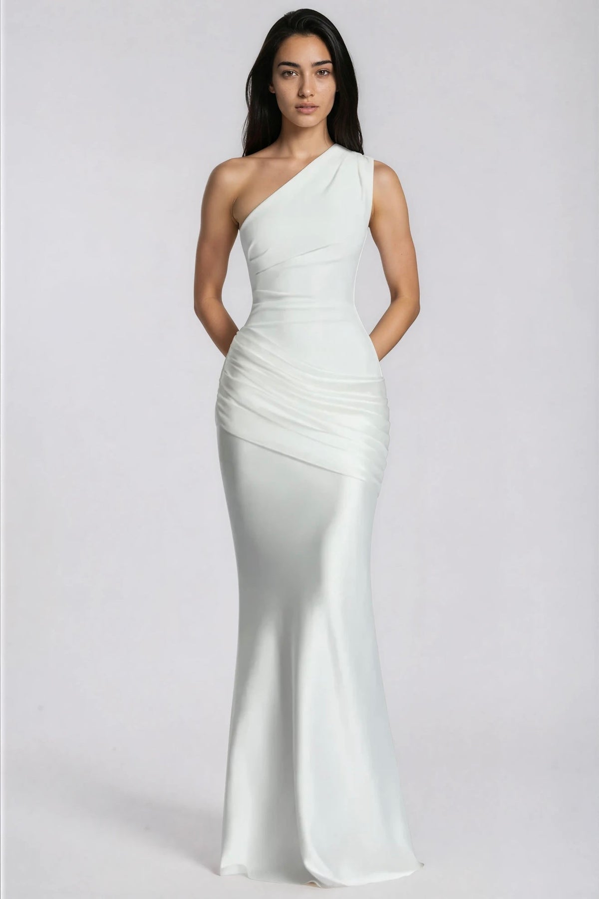 Front view of the white one-shoulder dress with arms behind the back, highlighting the ruched waist and satin drape. 12