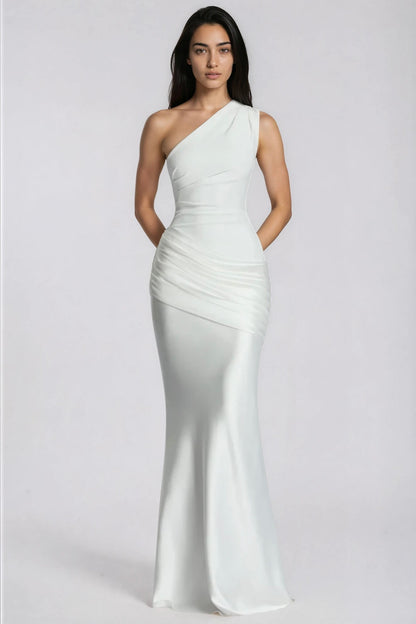 Front view of the white one-shoulder dress with arms behind the back, highlighting the ruched waist and satin drape. 12
