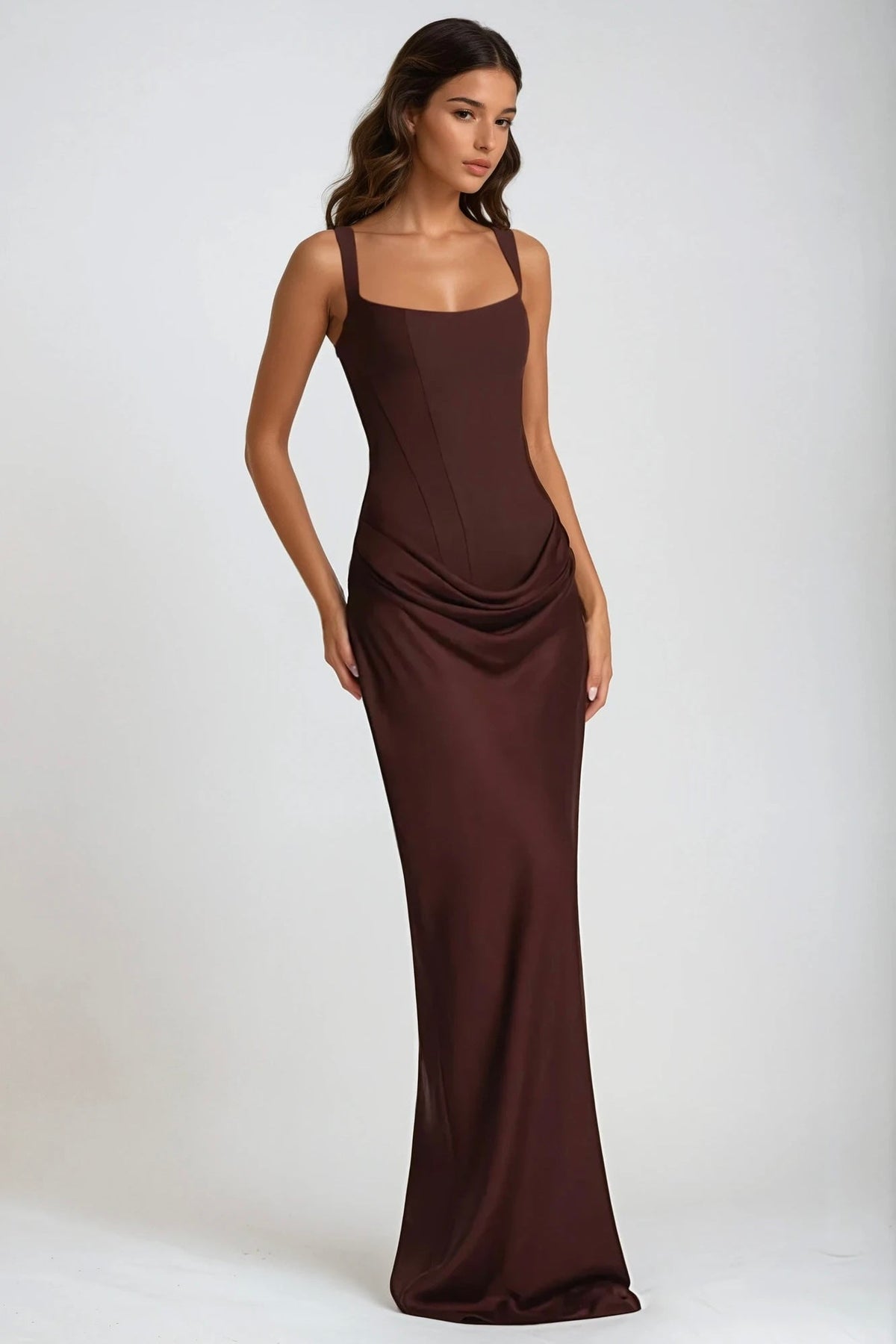 Three-quarter view of the brown maxi dress showing the corset seams and draped hip gathering 6