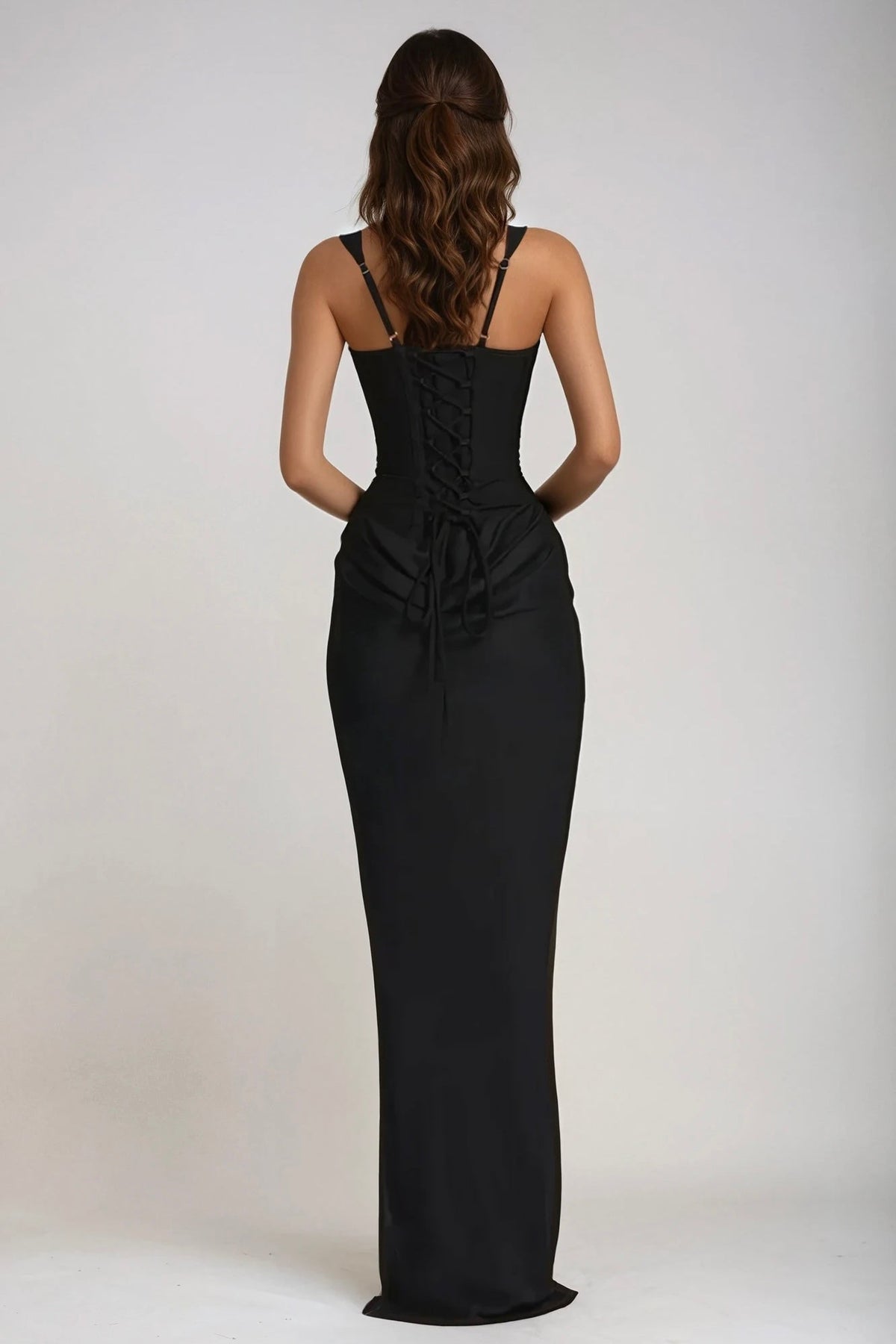 Back view of the black dress on a model, showing lace-up corset back and thin adjustable straps 27