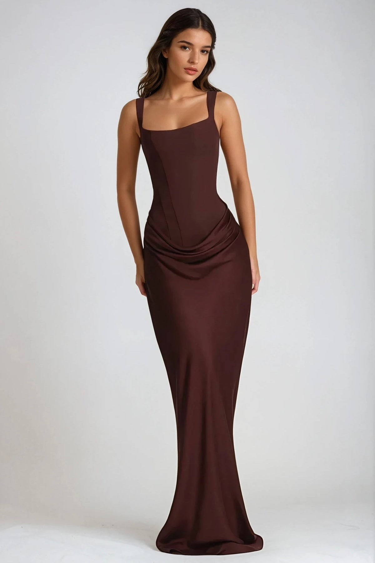 Model standing front-on in the dark chocolate brown satin-look maxi dress with ruched draping 5