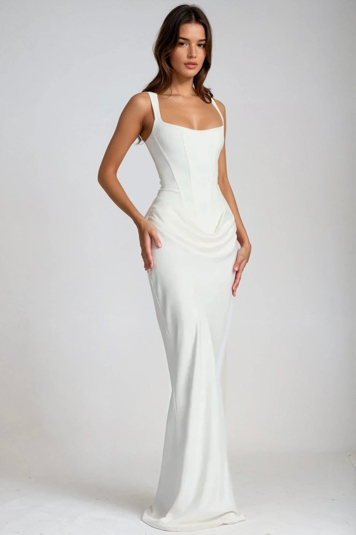 Model in a white maxi dress with square neckline, shown at a three-quarter angle 2