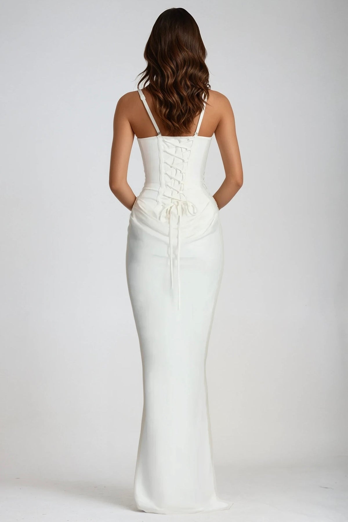 Back view of the white dress showing lace-up corset back, thin adjustable straps and trailing ties 3