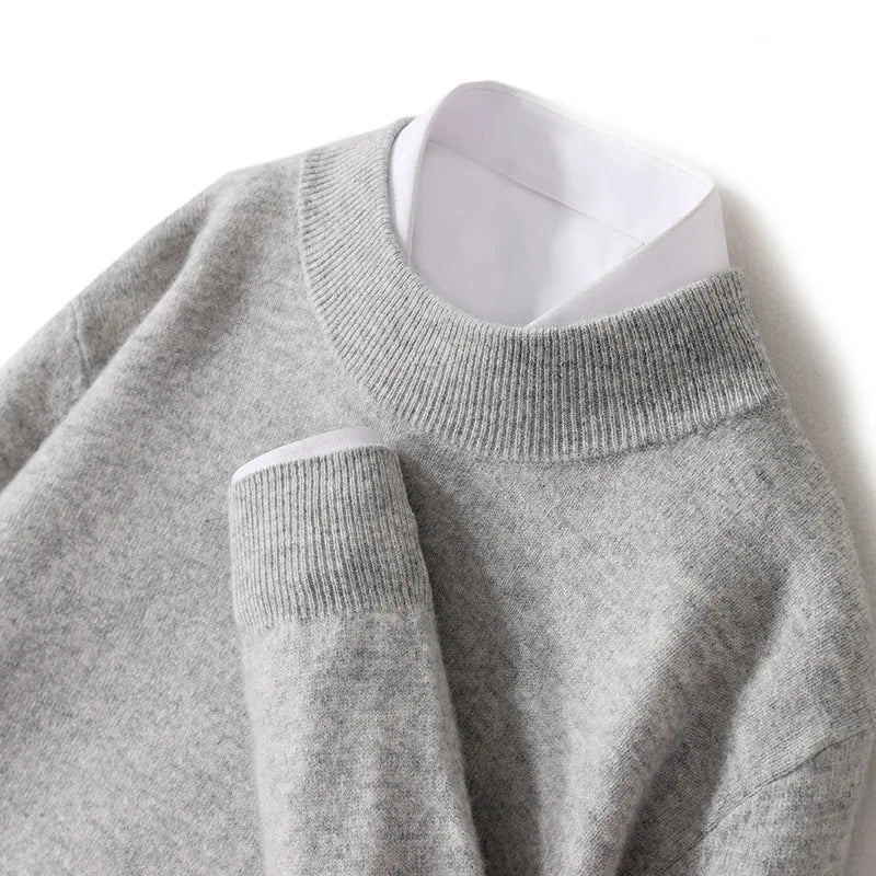 Close-up flat lay of the light grey knitted jumper with ribbed mock neck and cuff, white shirt beneath 24