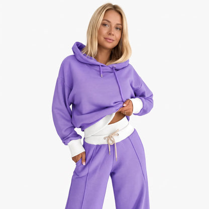 Model wearing the tracksuit in purple with white ribbed hem, cuffs and waistband, beige drawstring 24