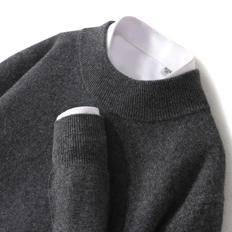 Close-up flat lay of the charcoal knitted jumper with ribbed mock neck and cuff, white shirt visible 26