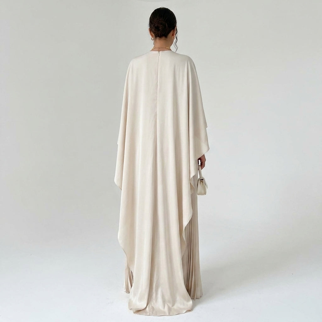 Back view of the cream dress on a model, showing the long cape drape and centre back zip 3