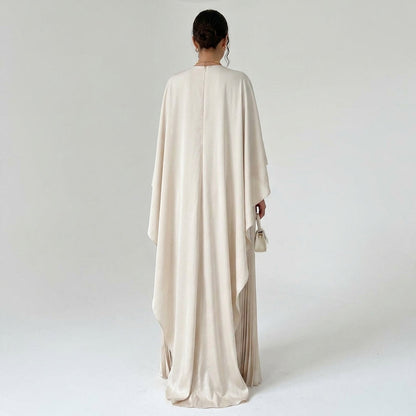 Back view of the cream dress on a model, showing the long cape drape and centre back zip 3
