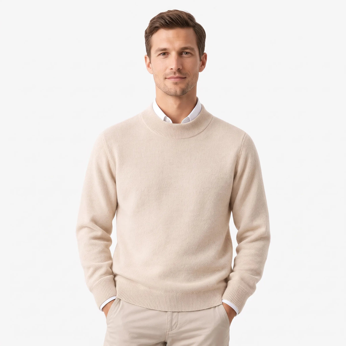 Man modelling the cream knitted jumper over a white collared shirt with beige trousers, hands in pockets 27