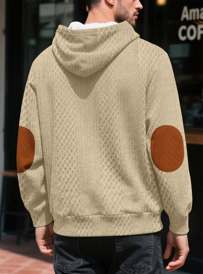 Back view of the beige hoodie on a model, showing large tan elbow patches 27