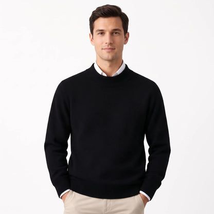 Man wearing the black knitted jumper layered over a white collared shirt with beige trousers 28