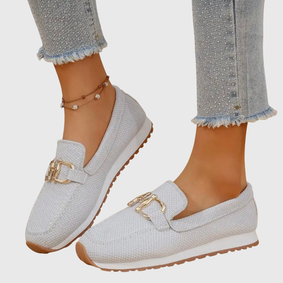Light grey mesh loafers with gold buckle, worn with one foot angled to show the side profile 4