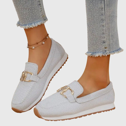Light grey mesh loafers with gold buckle, worn with one foot angled to show the side profile 4