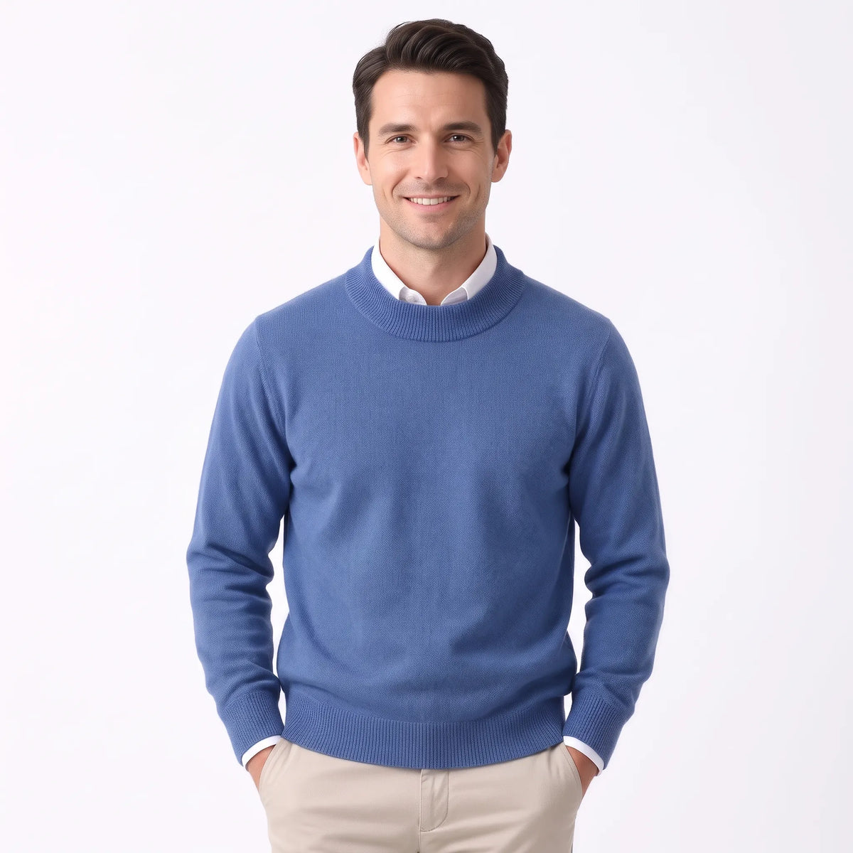 Smiling man wearing the mid blue knitted jumper over a white shirt and beige trousers 29