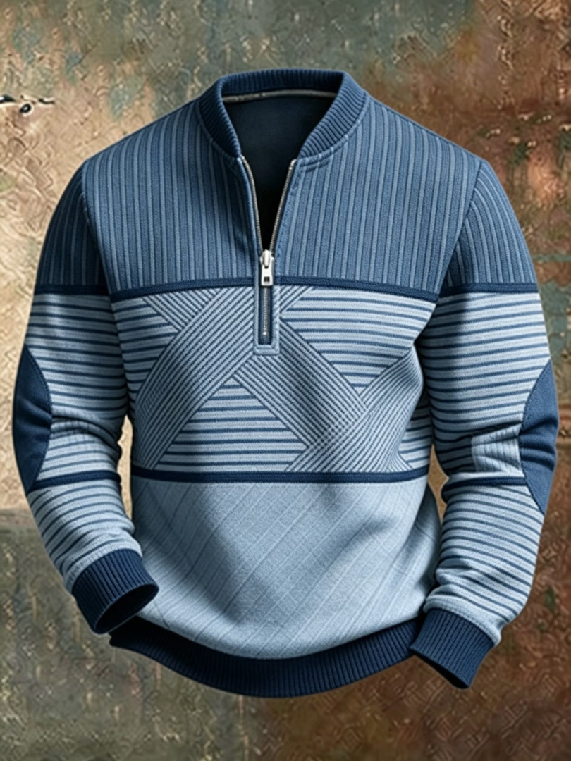 Front view of the half-zip sweater in two tones of blue, with elbow patches, ribbed hem and a crossed stripe pattern. 3