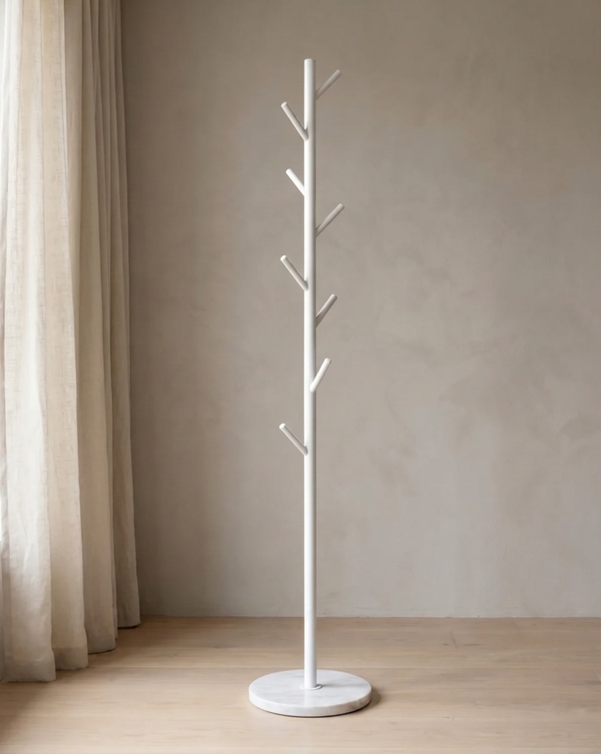 White version of the rack with a round marble-look base, standing empty beside a linen curtain. 2
