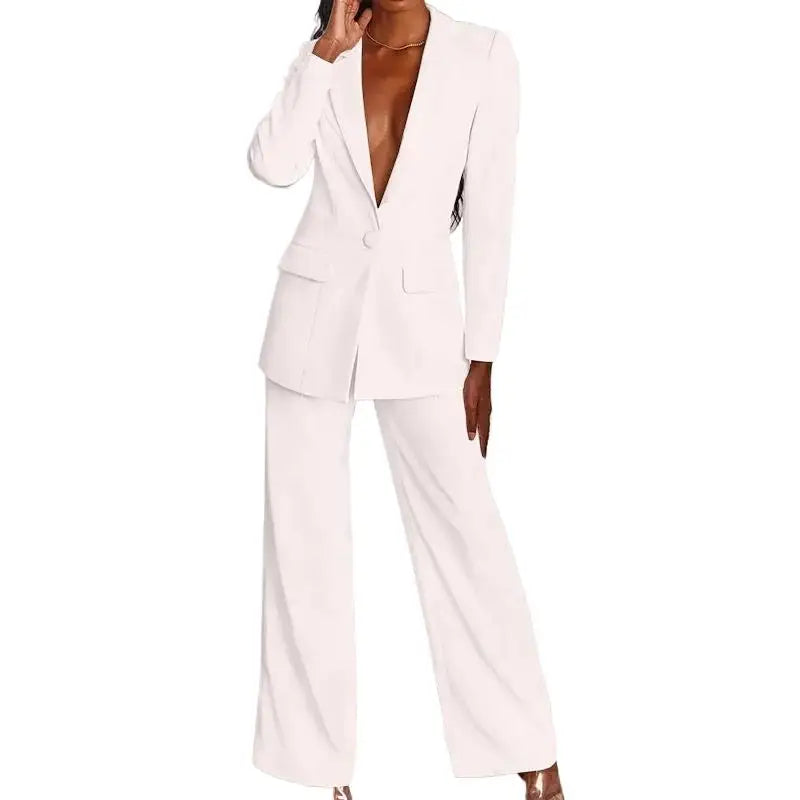 White blazer with flap pockets and wide-leg trousers, front view on a model, hand raised to her collarbone 2
