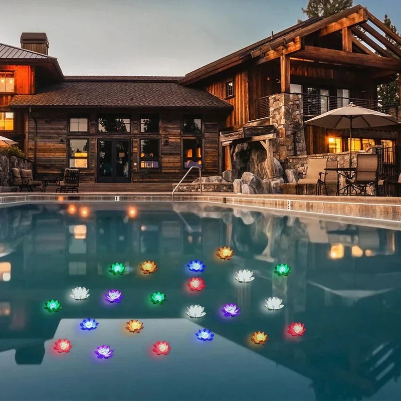 Many multicoloured glowing lotus lights floating on a swimming pool at dusk outside a timber house 7