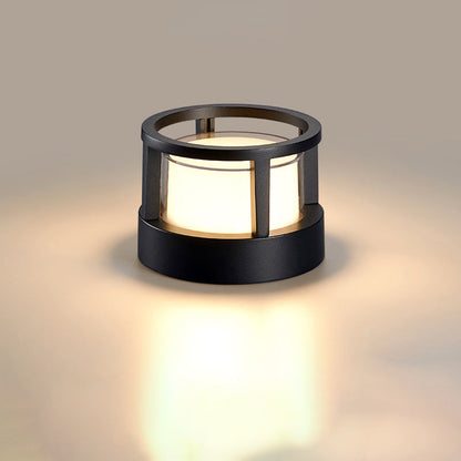 Round black light with open ring top and frosted white shade glowing warmly on a plain neutral background. 9