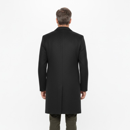 Back view of the coat worn by a model, showing the plain back panel and centre vent 3