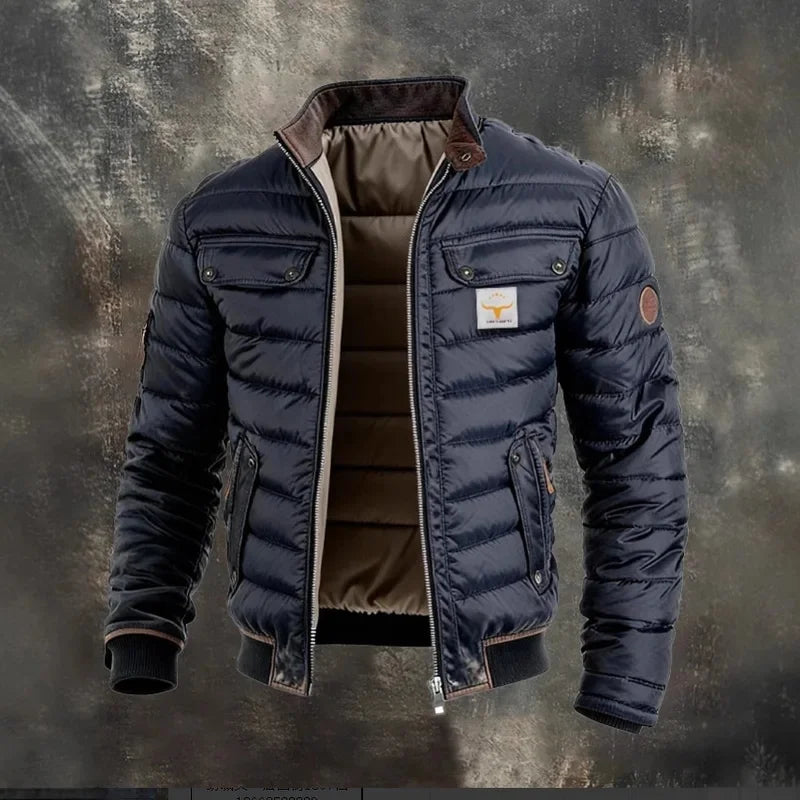 Navy quilted jacket unzipped on a textured grey backdrop, showing its brown padded lining and corduroy collar 2