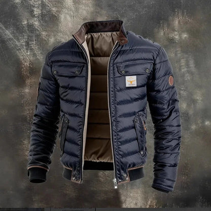 Navy quilted jacket unzipped on a textured grey backdrop, showing its brown padded lining and corduroy collar 2