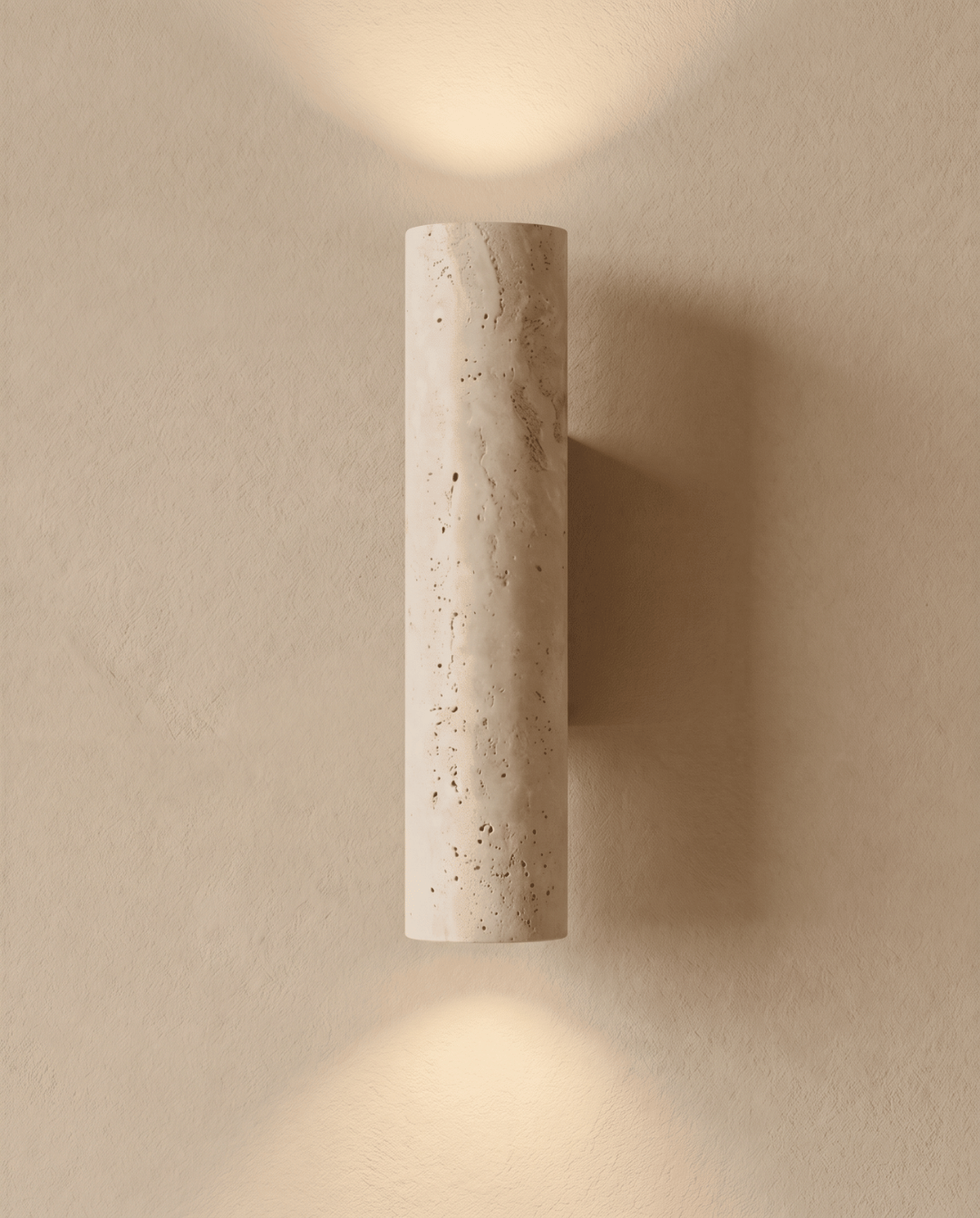 Wall light switched on, casting soft pools of light upwards and downwards on a plaster wall 2