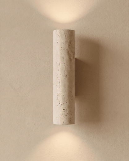 Wall light switched on, casting soft pools of light upwards and downwards on a plaster wall 2