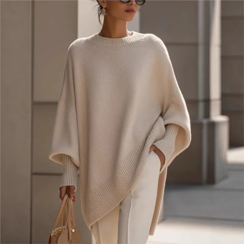 Cream jumper worn outdoors with white trousers, sunglasses and a beige handbag, cropped at the face 2