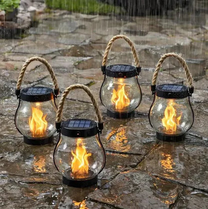 Four glowing lanterns with rope handles standing on wet paving in heavy rain 2