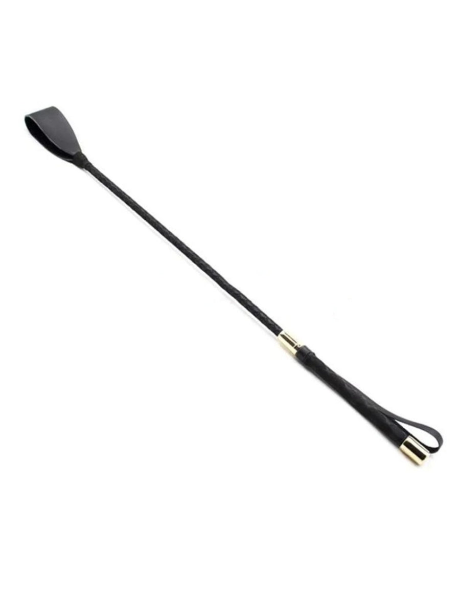 Black braided riding crop lying diagonally on white, with a flat leather tip, gold-toned collars and a wrist loop. 1