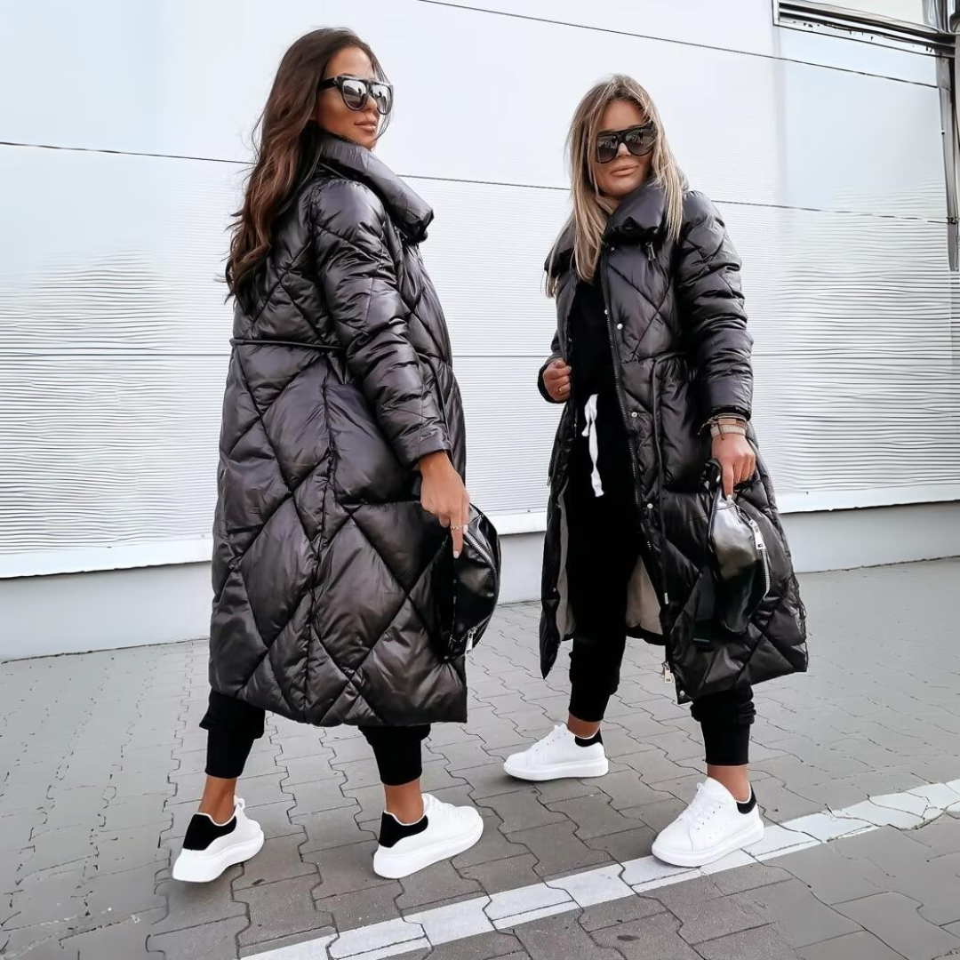 Two women stand side by side in the black quilted long coat, one shown from the side and one from the front. 4