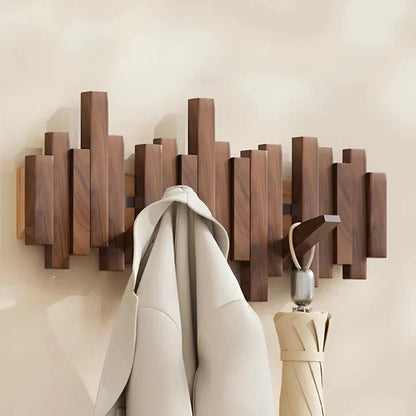 Dark wooden rack with a cream coat and a closed cream umbrella hanging from folded-down hooks 8