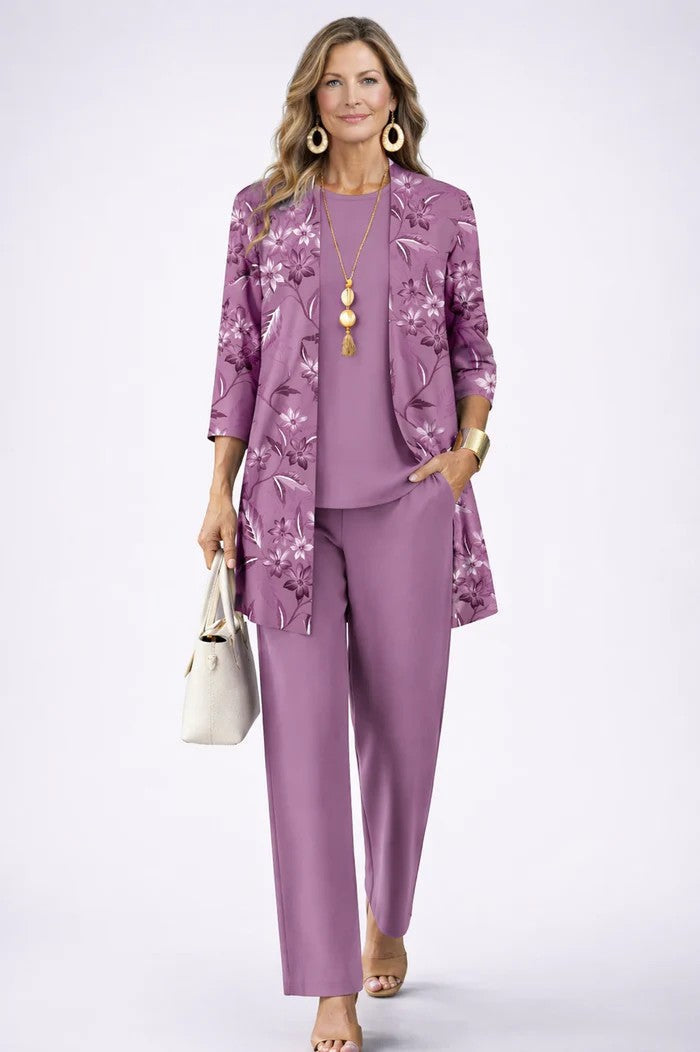 Model in lilac set: floral print cardigan over plain top and trousers, one hand in pocket 4