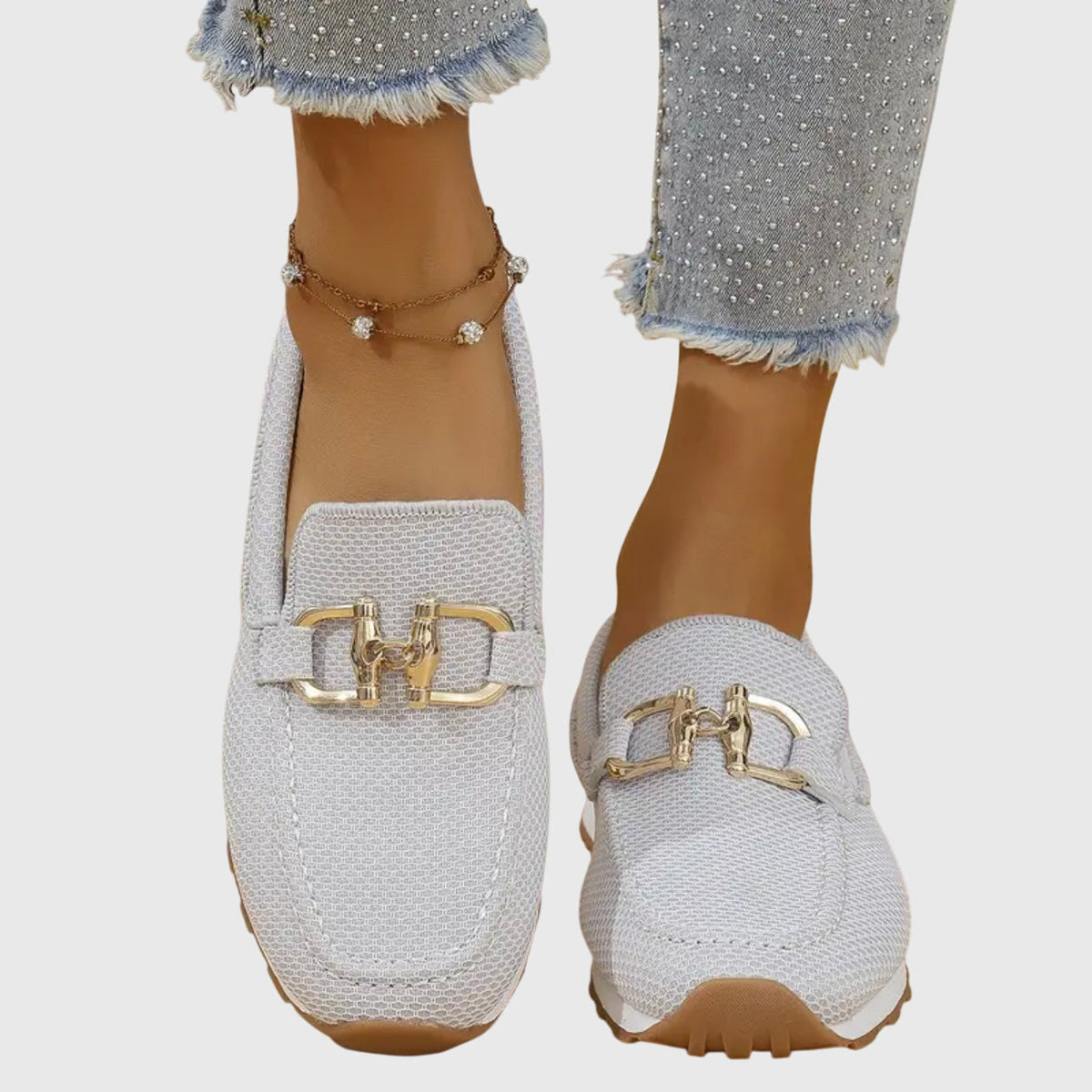 Light grey mesh loafers worn front-on, showing the toe shape, stitching and gold buckle 9