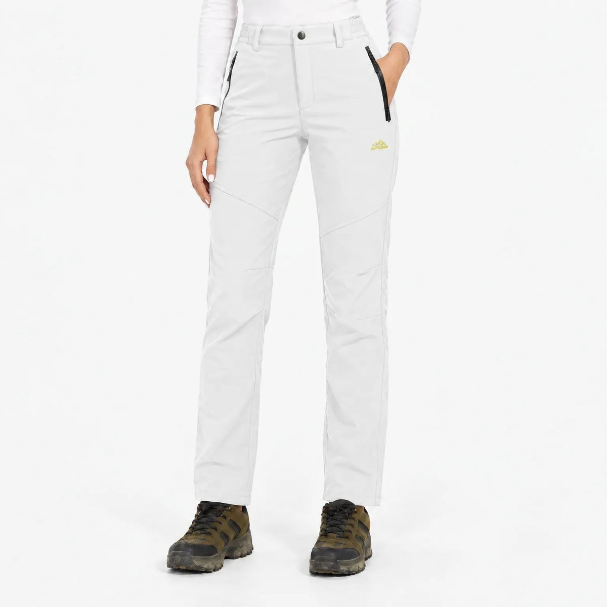 White trousers worn by a model with hiking boots, front view with black zip pockets 15