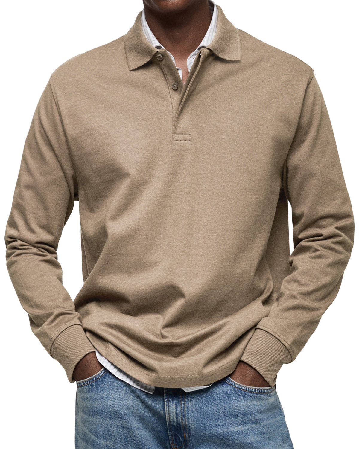 Model wearing the polo in tan beige, relaxed fit with hands in jeans pockets and a striped shirt underneath. 8