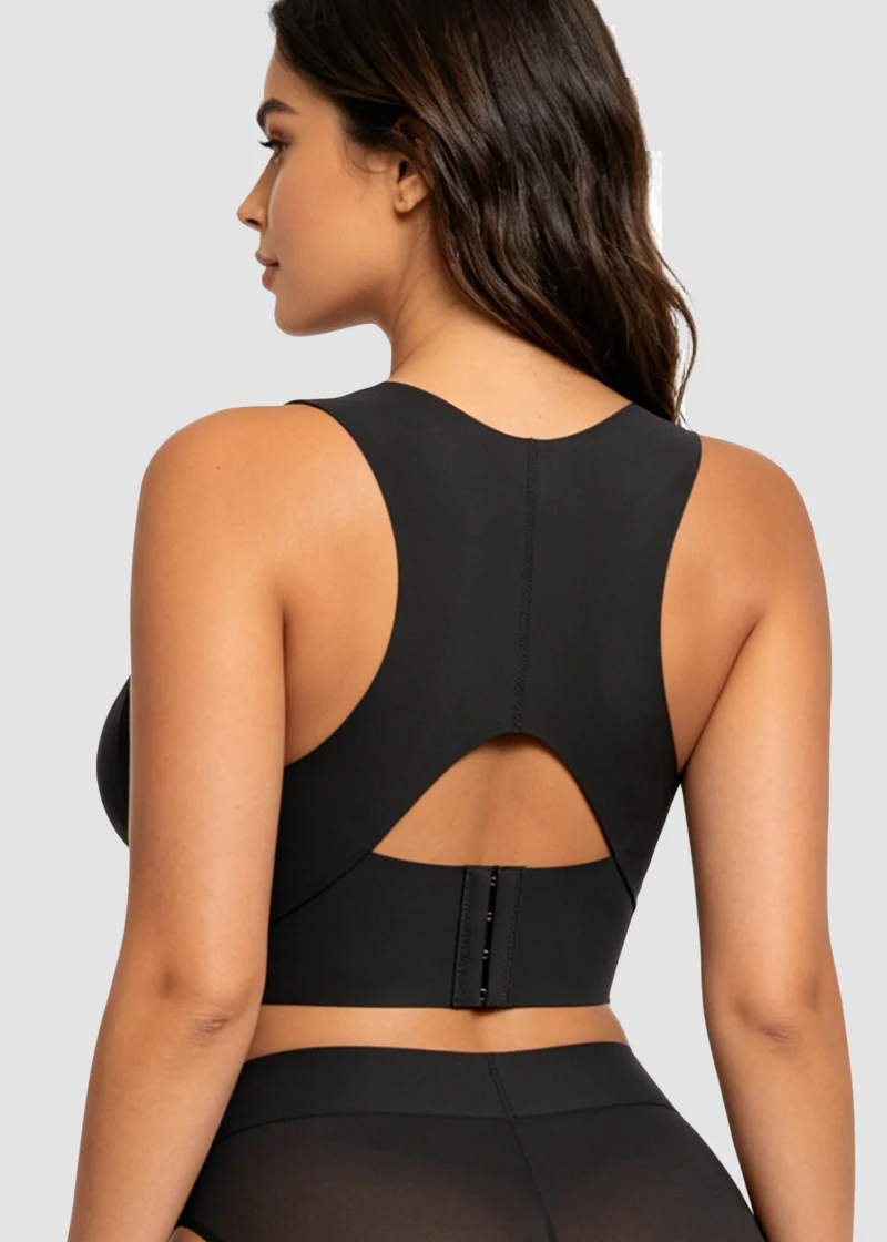 Back view of the black bra on a model, showing the racer back, cut-out and hook closure. 16