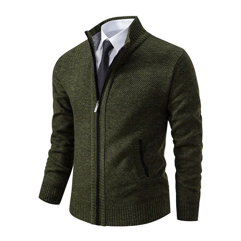 Angled view of the dark green cardigan showing the zip, black-edged pocket and ribbed hem 30