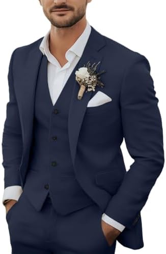 Bearded model wears the navy suit jacket and waistcoat over a white shirt, with a floral buttonhole and pocket square. 1