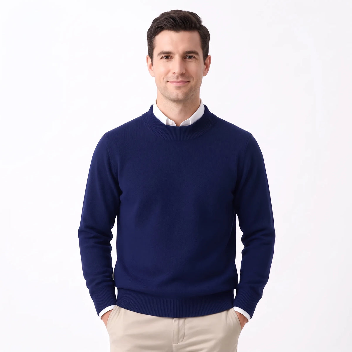 Man wearing the navy knitted jumper over a white collared shirt with beige trousers 32