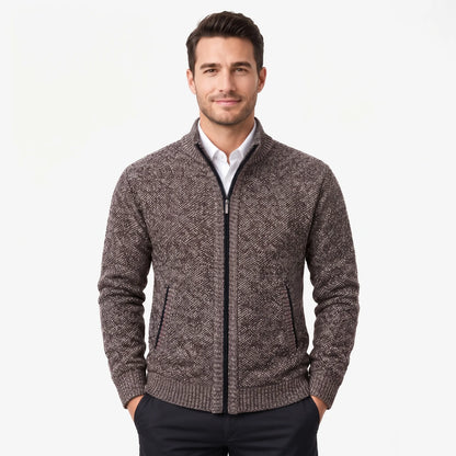 Model wearing the brown marl cardigan zipped up over a white shirt, hands in trouser pockets 33