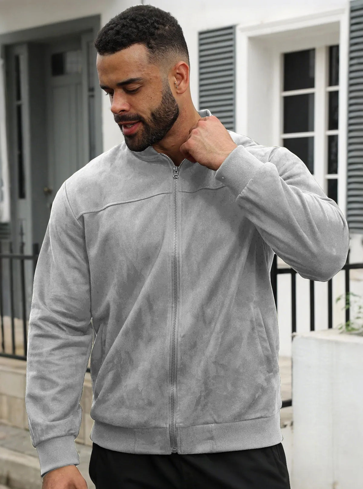 Back view of the blue-grey jacket laid flat, showing plain back and ribbed hem 34
