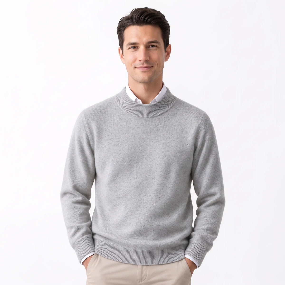 Man wearing the light grey knitted jumper over a white collared shirt with beige trousers 34
